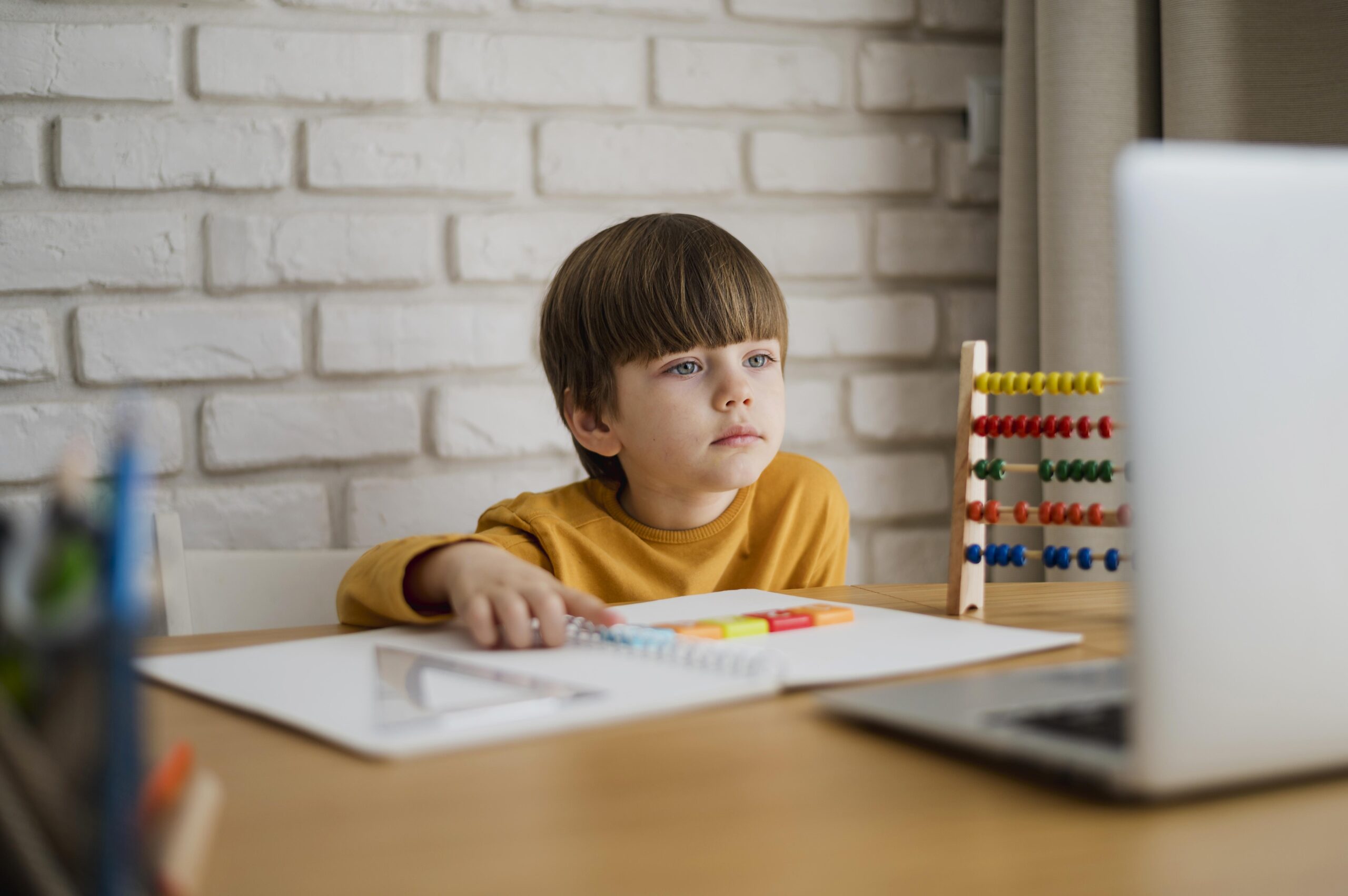 front-view-child-desk-learning-from-laptop