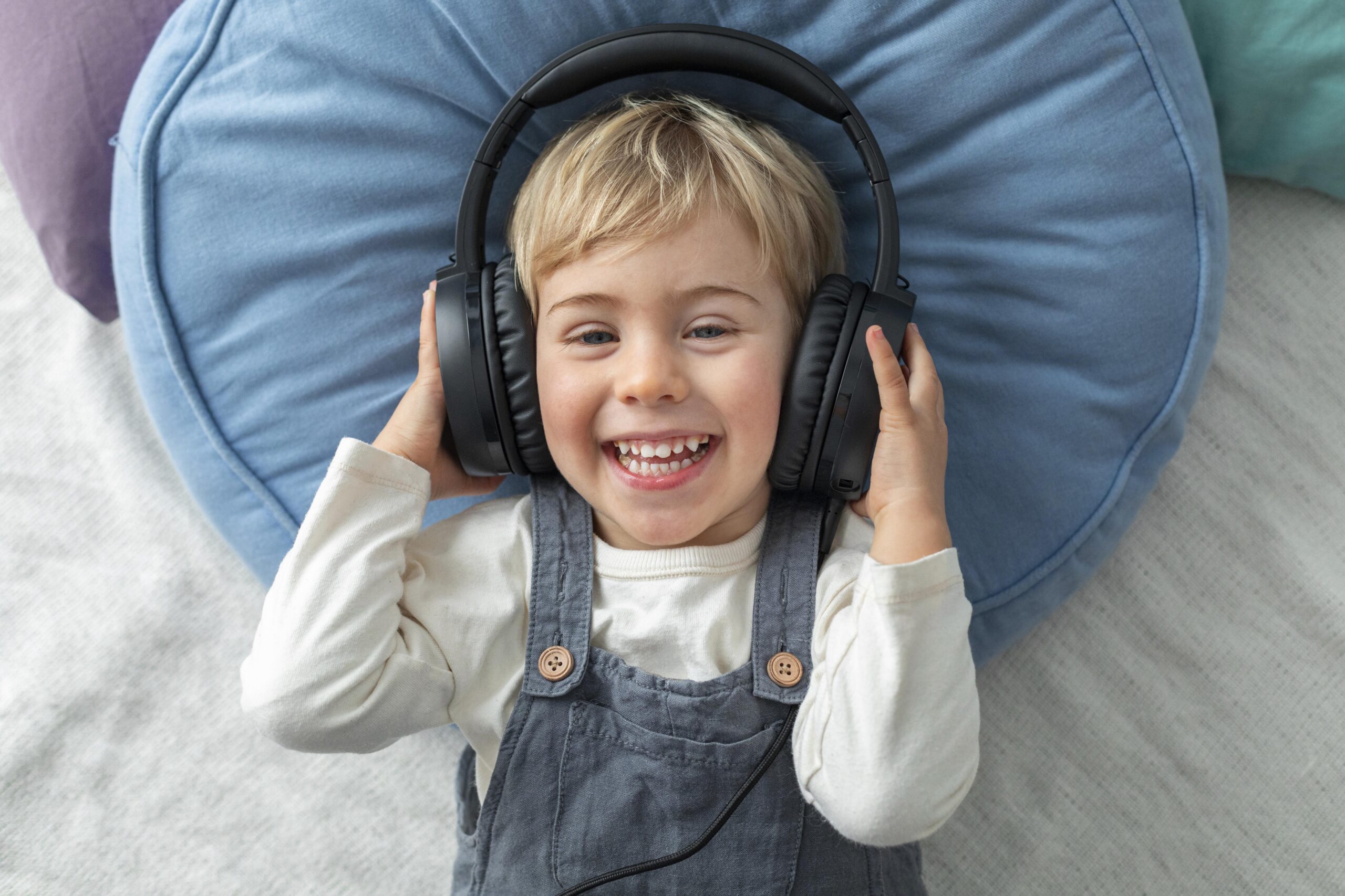 top-view-boy-listening-music-headphones